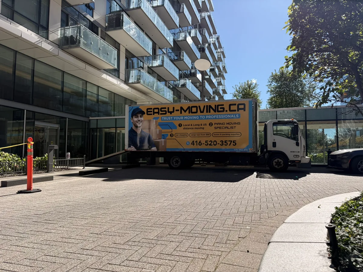 Easy Moving branded truck outside a modern residential building