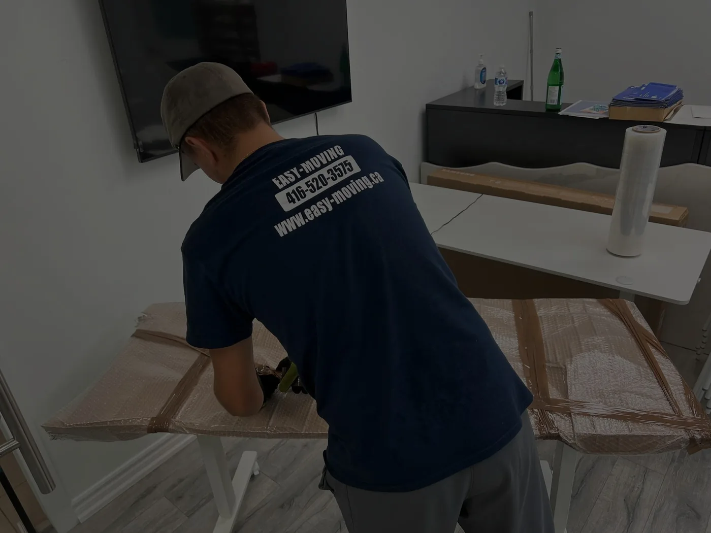Easy Moving crew member disassembling a table